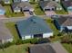 An aerial view of the house shows a screen patio and well manicured landscaping at 3686 Plymouth Dr, Winter Haven, FL 33884
