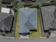 Aerial view of the house shows landscaping, grass, and a dark colored roof at 3686 Plymouth Dr, Winter Haven, FL 33884