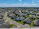 An aerial view of a home in a neatly planned community featuring well-manicured lawns and quiet residential streets at 3686 Plymouth Dr, Winter Haven, FL 33884