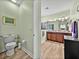 A bright and airy bathroom with wood-look flooring, a toilet, and double vanity at 3686 Plymouth Dr, Winter Haven, FL 33884