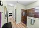 Modern bathroom featuring wood-look flooring, a tiled shower, and light-green colored walls at 3686 Plymouth Dr, Winter Haven, FL 33884