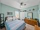 Bedroom with bright blue walls, wooden furniture, and a ceiling fan at 3686 Plymouth Dr, Winter Haven, FL 33884
