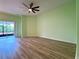 Light-filled bedroom showcasing wood floors, sliding door access, and neutral decor at 3686 Plymouth Dr, Winter Haven, FL 33884