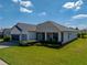 Well-maintained home with a lush lawn, manicured bushes, and a screened-in porch for outdoor enjoyment at 3686 Plymouth Dr, Winter Haven, FL 33884