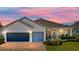 Charming single-story home featuring a brick driveway, two-car garage, and meticulously landscaped front yard at 3686 Plymouth Dr, Winter Haven, FL 33884