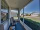 Relaxing screened-in porch with comfortable seating and a view of the quiet residential street at 3686 Plymouth Dr, Winter Haven, FL 33884