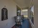 Cozy screened-in porch featuring two chairs, a small table, and a welcoming ambiance at 3686 Plymouth Dr, Winter Haven, FL 33884