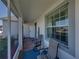Enclosed front porch with seating, overlooking manicured landscaping and the entrance to the house at 3686 Plymouth Dr, Winter Haven, FL 33884