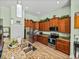Kitchen with stainless steel appliances, granite countertops, wooden cabinets, and wood look flooring at 3686 Plymouth Dr, Winter Haven, FL 33884