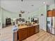 Open kitchen with stainless steel appliances, granite countertops, breakfast bar, and access to living areas at 3686 Plymouth Dr, Winter Haven, FL 33884