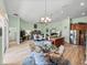 Open-concept kitchen and dining area with stainless steel appliances, island, and wood look floors at 3686 Plymouth Dr, Winter Haven, FL 33884