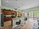 Kitchen featuring granite countertops, breakfast bar, stainless appliances, and tile flooring at 3686 Plymouth Dr, Winter Haven, FL 33884