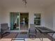 Open view from lanai to living area, with outdoor seating and a welcoming entrance mat at 3686 Plymouth Dr, Winter Haven, FL 33884