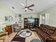 Inviting living room with a ceiling fan, hardwood floors, built in bookcase, and ample natural light at 3686 Plymouth Dr, Winter Haven, FL 33884
