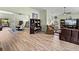 Open living space with hardwood floors, comfortable seating, and a view into the dining area at 3686 Plymouth Dr, Winter Haven, FL 33884