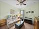 Living room with green walls, neutral carpet, ceiling fan, and unique coffee table at 3686 Plymouth Dr, Winter Haven, FL 33884