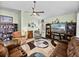 Well-decorated living room featuring ceiling fan, a large screen TV, and comfortable recliner seating at 3686 Plymouth Dr, Winter Haven, FL 33884