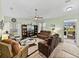Spacious living room showcasing comfortable seating, large TV, ceiling fan, and natural light at 3686 Plymouth Dr, Winter Haven, FL 33884