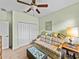 Living room with green walls, neutral carpet, ceiling fan, and unique coffee table at 3686 Plymouth Dr, Winter Haven, FL 33884