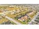 Expansive aerial view showcases a neighborhood with well-maintained homes, terracotta roofs and generous lawn sizes at 369 Villa Sorrento Cir, Haines City, FL 33844