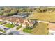An aerial view of a single-Gathering home with a terracotta tile roof and lush landscaping in a tranquil neighborhood at 369 Villa Sorrento Cir, Haines City, FL 33844