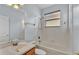 Bathroom featuring a tub with shower head, window and vanity with sink at 369 Villa Sorrento Cir, Haines City, FL 33844