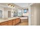 Bright bathroom with double sinks, soaking tub, a tiled shower, and a large window at 369 Villa Sorrento Cir, Haines City, FL 33844