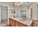 Bathroom featuring double vanity with a large mirror, wood cabinets, and neutral walls at 369 Villa Sorrento Cir, Haines City, FL 33844