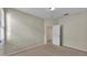 Neutral bedroom features carpeted floors and a white door open to another room at 369 Villa Sorrento Cir, Haines City, FL 33844