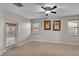 Light and airy bedroom with a ceiling fan, neutral carpet, and two palm tree wall art pieces at 369 Villa Sorrento Cir, Haines City, FL 33844