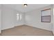 Neutral bedroom with two windows and neutral walls and carpet at 369 Villa Sorrento Cir, Haines City, FL 33844