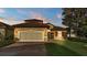 Charming home features a well-manicured lawn, two-car garage and a tile roof at 369 Villa Sorrento Cir, Haines City, FL 33844