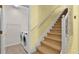 View of carpeted stairs with laundry room to the left at 369 Villa Sorrento Cir, Haines City, FL 33844