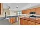 Well-lit kitchen featuring wood cabinets, stainless steel appliances, and a stylish wood-block island at 369 Villa Sorrento Cir, Haines City, FL 33844