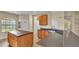 Kitchen with island workspace, breakfast bar, and stainless steel sink at 369 Villa Sorrento Cir, Haines City, FL 33844