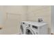 Laundry room with large washer and dryer and wire shelving at 369 Villa Sorrento Cir, Haines City, FL 33844