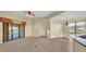 Bright living room featuring neutral walls, carpet, tile floor, and sliding glass doors leading to the outside at 369 Villa Sorrento Cir, Haines City, FL 33844