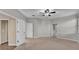 Large carpeted main bedroom featuring a ceiling fan, neutral paint, and access to the ensuite bath at 369 Villa Sorrento Cir, Haines City, FL 33844