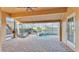 Covered patio with brick pavers, ceiling fan, and a hammock overlooking a pool and hot tub at 369 Villa Sorrento Cir, Haines City, FL 33844