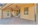 Outdoor covered patio with brick pavers, ceiling fan, and hammock at 369 Villa Sorrento Cir, Haines City, FL 33844