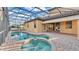 Aerial view of pool and spa with screened enclosure and outdoor patio area at 369 Villa Sorrento Cir, Haines City, FL 33844