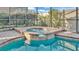 Close up of the hot tub, showing blue water and the brick surround at 369 Villa Sorrento Cir, Haines City, FL 33844