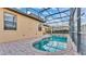Backyard swimming pool and brick patio with screened enclosure at 369 Villa Sorrento Cir, Haines City, FL 33844