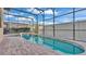 Screened-in pool featuring a brick patio and a tranquil backyard view at 369 Villa Sorrento Cir, Haines City, FL 33844