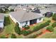 Beautifully maintained backyard showcasing lush green grass, a screened-in porch, and carefully manicured hedges at 3711 Plymouth Dr, Winter Haven, FL 33884