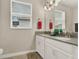 Bright, dual-sink bathroom featuring lots of natural light and a large vanity with modern fixtures at 3711 Plymouth Dr, Winter Haven, FL 33884