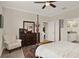 Spacious bedroom featuring a dark wood dresser, neutral paint, and access to an en-suite bathroom at 3711 Plymouth Dr, Winter Haven, FL 33884