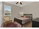 This cozy bedroom features a ceiling fan and a chair, next to a large sunny window at 3711 Plymouth Dr, Winter Haven, FL 33884