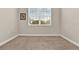 Bright, carpeted bedroom with a large window offering natural light and view of the neighborhood at 3711 Plymouth Dr, Winter Haven, FL 33884