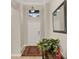 Bright and airy entryway featuring a decorative rug, a mirror, and a stylish console table at 3711 Plymouth Dr, Winter Haven, FL 33884